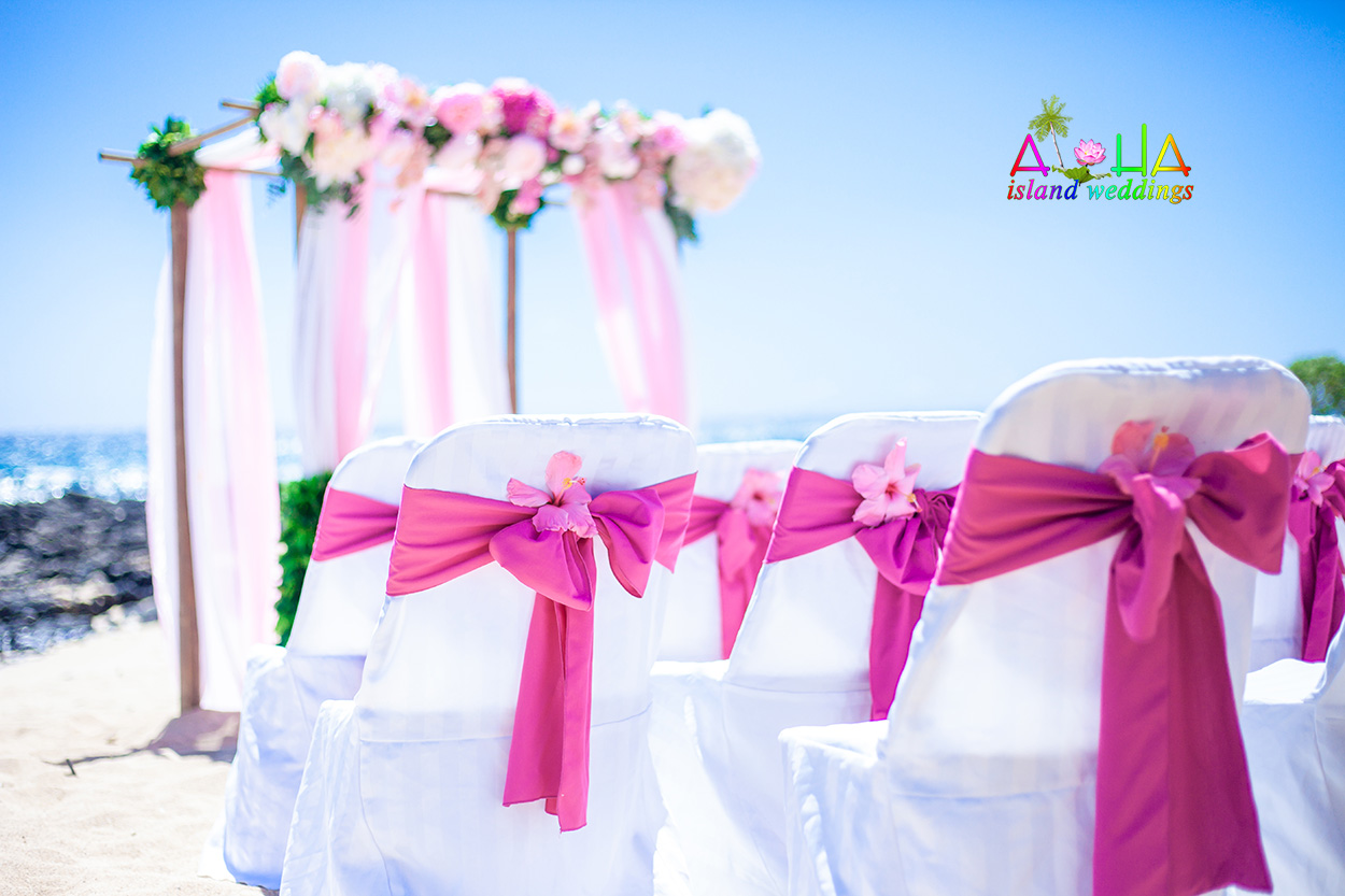Hawaii beach wedding arch orchids hanging as flower arrangements